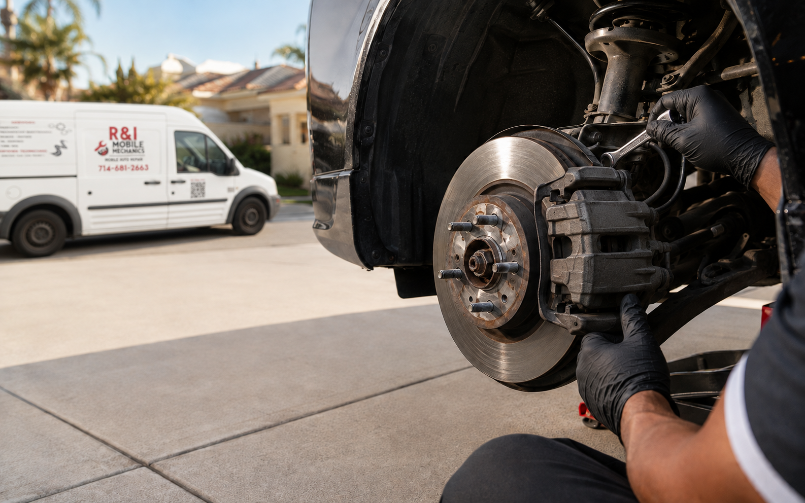 R&I mobile mechanic servicing a vehicle's brake system in a residential driveway